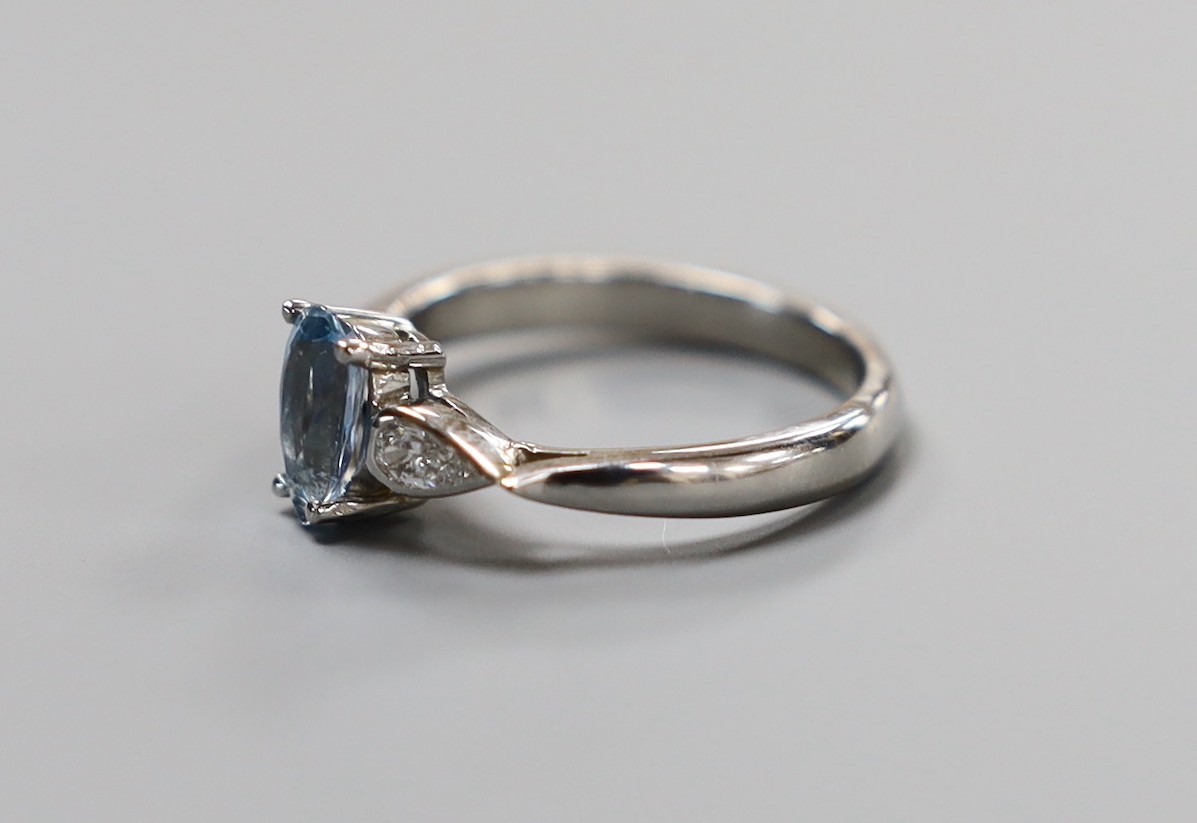 A modern platinum, pear cut aquamarine and two stone pear cut diamond set dress ring, size N, gross weight 5.3 grams